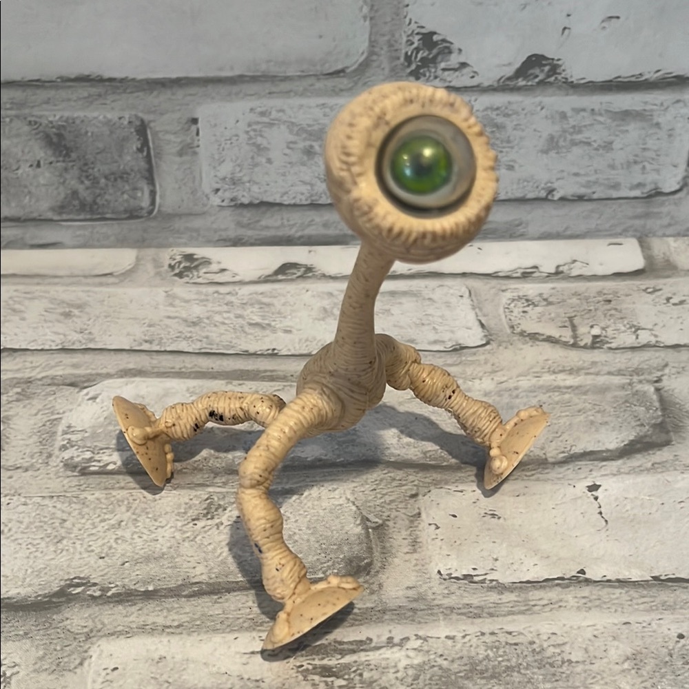 Ocula 1998 Beige Figurine with Green Eye bendable toy